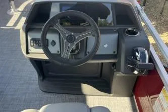 Slide: The Image of 2026 Sun Tracker SportFish 20 DLX boat dashboard with steering wheel and controls. - 7