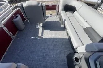 Slide: The Image of 2026 Sun Tracker SportFish 20 DLX pontoon boat interior with gray seating and carpet. - 4