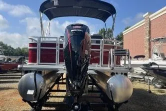 Slide: The Image of 2026 Sun Tracker SportFish 20 DLX pontoon boat with canopy, displayed outdoors. - 1