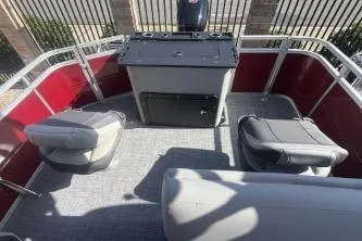 Slide: The Image of 2026 Sun Tracker SportFish 20 DLX pontoon boat interior with seating and control console. - 9
