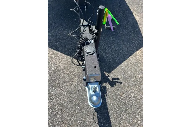Slide: The Image of Trailer hitch of 2026 Tracker Grizzly 1860 CC on asphalt surface. - 6