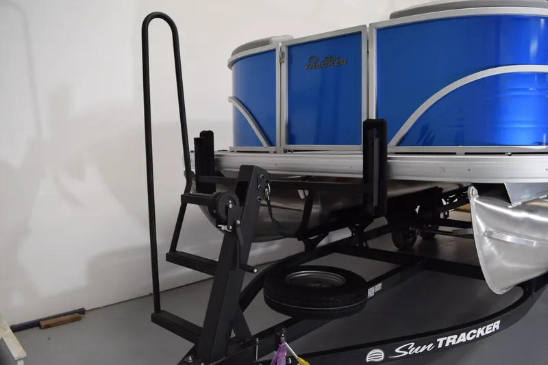 Slide: The Image of 2026 Sun Tracker Party Barge 20 DLX pontoon boat on trailer in garage. - 18