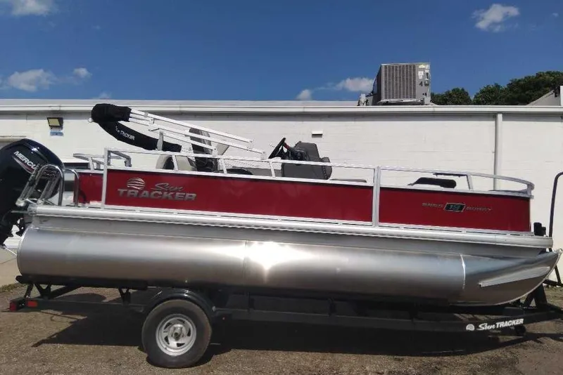 Slide: The Image of 2026 Sun Tracker Bass Buggy 18 DLX pontoon boat on trailer, red and silver design. - 6