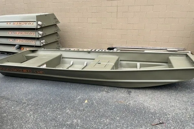 The Image of 2026 Tracker Grizzly 15 Jon boat in a storage area, showcasing its durable design. - 0