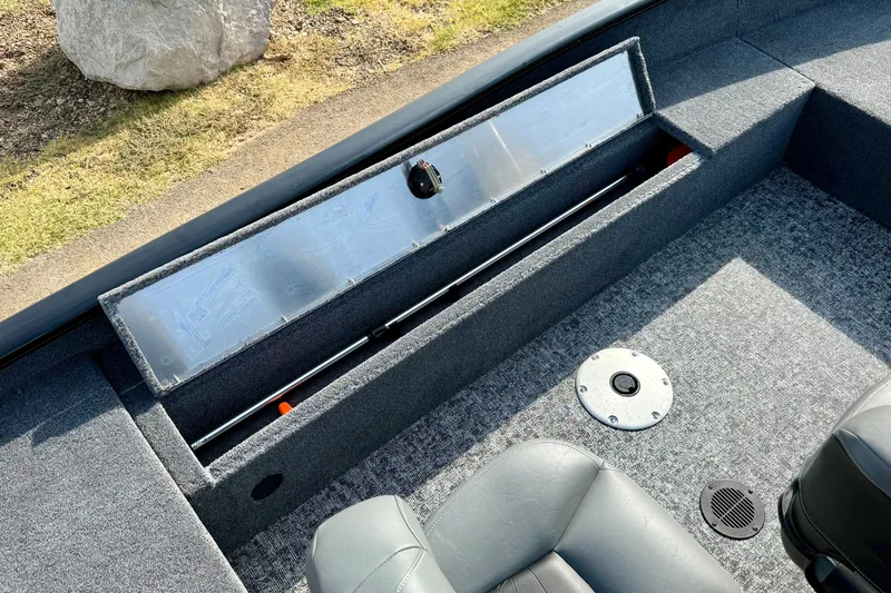 Slide: The Image of 2026 Tracker Super Guide V-16 SC boat interior with open storage compartment. - 14