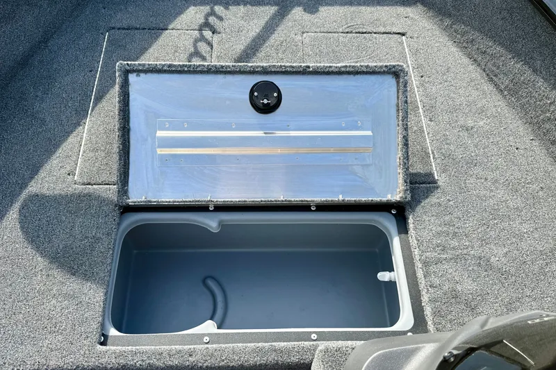 Slide: The Image of Open storage compartment in 2026 Tracker Super Guide V-16 SC boat. - 13