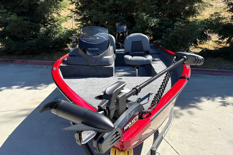 Slide: The Image of 2026 Tracker Super Guide V-16 SC boat with Minn Kota trolling motor, parked outdoors. - 14