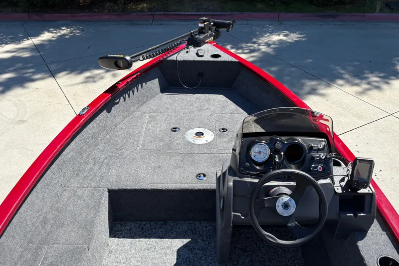 Slide: The Image of 2026 Tracker Super Guide V-16 SC boat interior with steering console and trolling motor. - 16