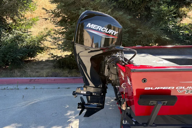 Slide: The Image of 2026 Tracker Super Guide V-16 SC boat with Mercury outboard motor, parked outdoors. - 11