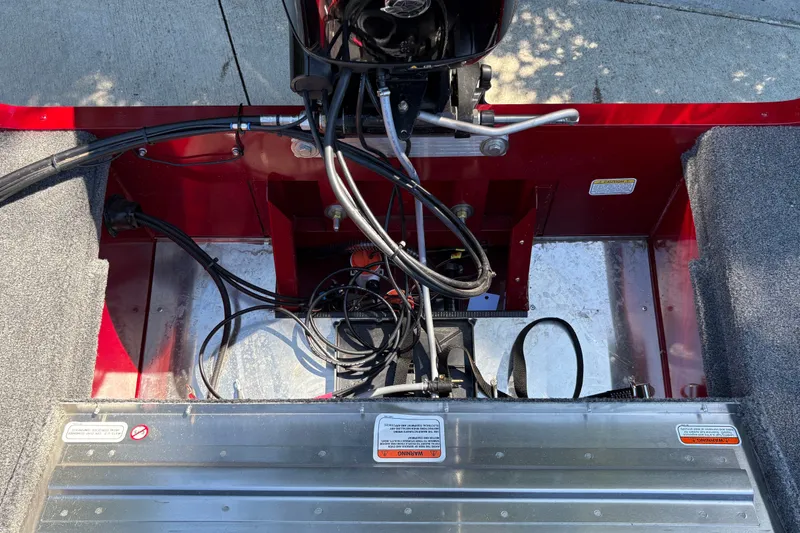 Slide: The Image of Interior view of a 2026 Tracker Super Guide V-16 SC boat, showcasing wiring and engine components. - 23