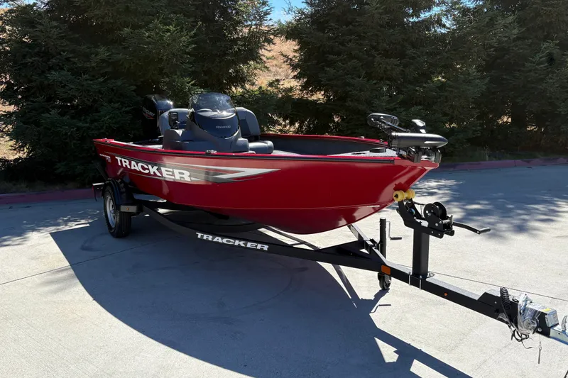 Slide: The Image of 2026 Tracker Super Guide V-16 SC boat in vibrant red on a trailer. - 5