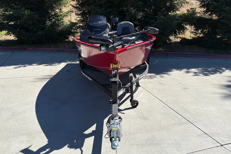 Slide: The Image of 2026 Tracker Super Guide V-16 SC boat on trailer, parked outdoors. - 13