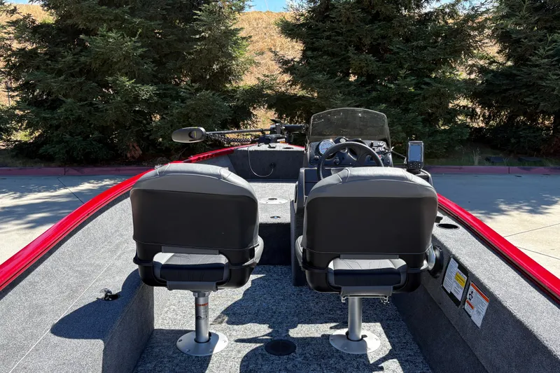 Slide: The Image of 2026 Tracker Super Guide V-16 SC boat interior with dual seats and steering console. - 25