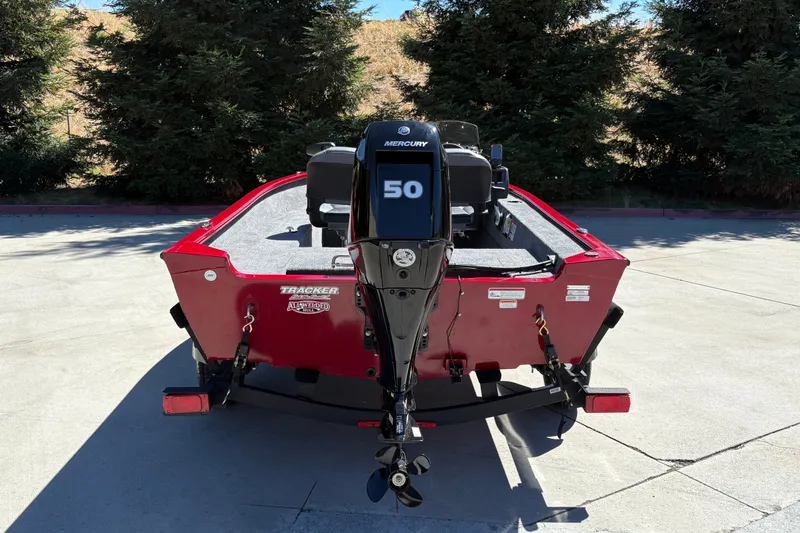 Slide: The Image of 2026 Tracker Super Guide V-16 SC boat with Mercury 50 engine, parked outdoors. - 9