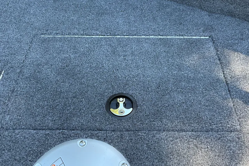 Slide: The Image of Carpeted deck of 2026 Tracker Super Guide V-16 SC boat with hatch and latch. - 28