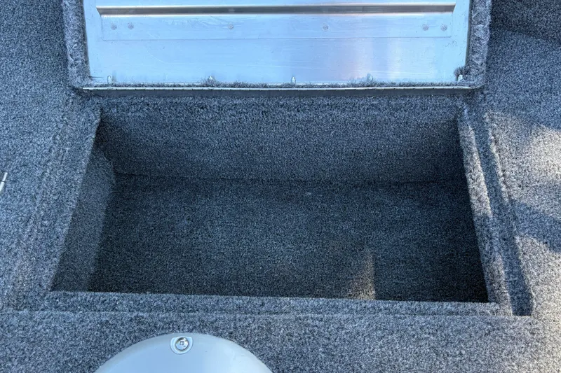Slide: The Image of Carpeted storage compartment in 2026 Tracker Super Guide V-16 SC boat. - 26