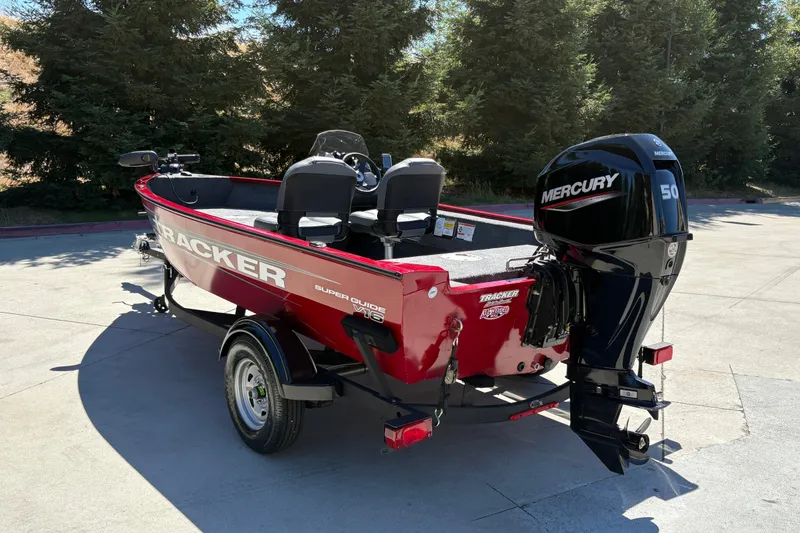 Slide: The Image of 2026 Tracker Super Guide V-16 SC boat with Mercury 50 engine, parked outdoors. - 7