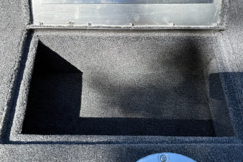 Slide: The Image of Carpeted storage compartment in 2026 Tracker Super Guide V-16 SC boat. - 27