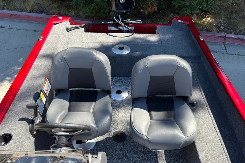 Slide: The Image of 2026 Tracker Super Guide V-16 SC boat interior with two gray seats and steering wheel. - 15