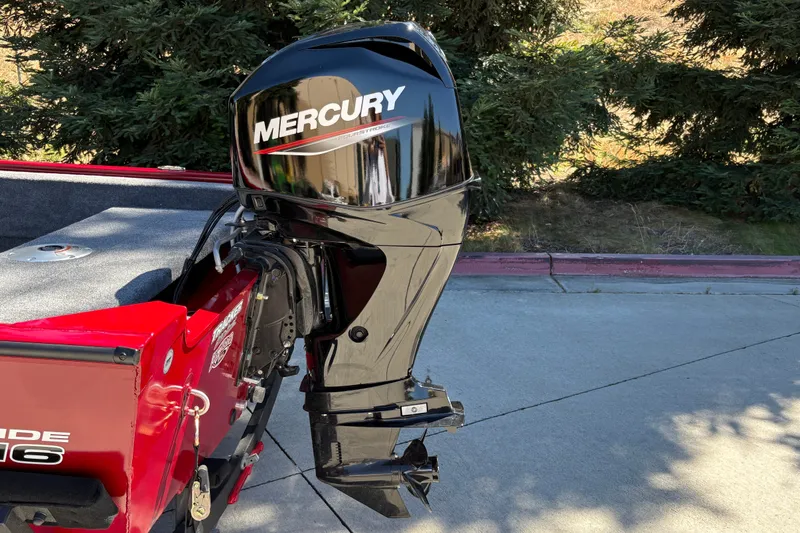 Slide: The Image of 2026 Tracker Super Guide V-16 SC with Mercury outboard motor in a driveway setting. - 12