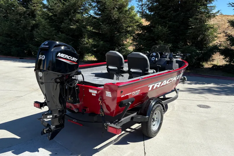 Slide: The Image of 2026 Tracker Super Guide V-16 SC boat with Mercury 50 engine, parked outdoors. - 10