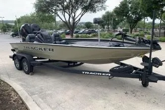The Image of 2026 Tracker Savage 215 boat on trailer in parking lot. - 0