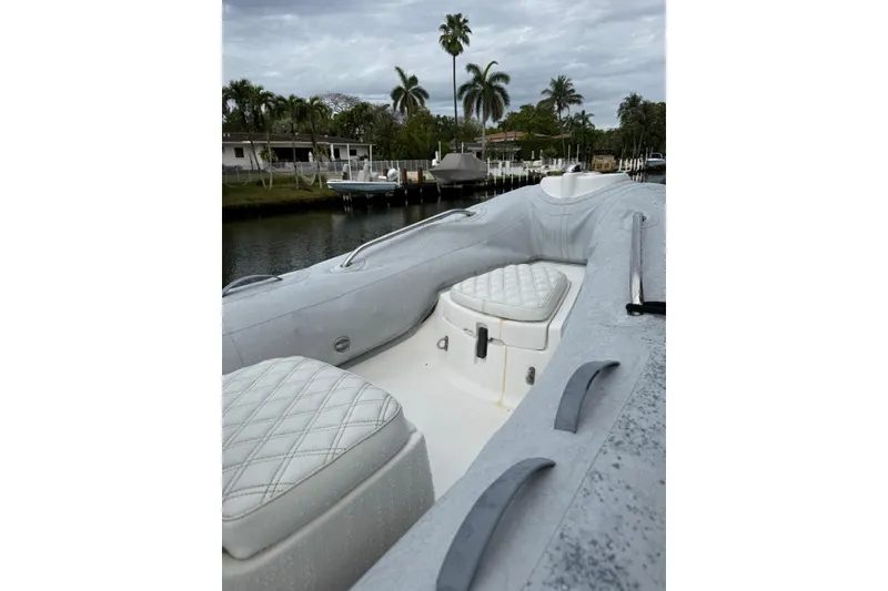 Slide: The Image of 2015 AB Inflatables Navigo 15 VS boat with quilted seating, docked near palm trees. - 10