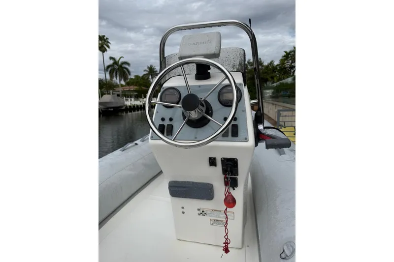 Slide: The Image of 2015 AB Inflatables Navigo 15 VS boat console with steering wheel and controls. - 2