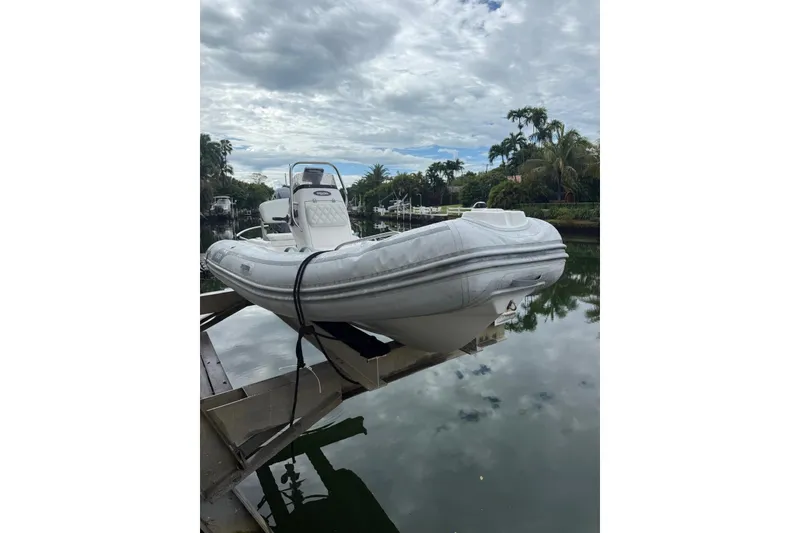 Slide: The Image of 2015 AB Inflatables Navigo 15 VS boat on a lift by a calm waterway. - 3