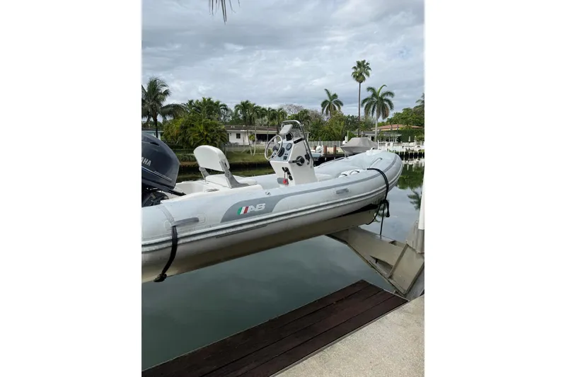 Slide: The Image of 2015 AB Inflatables Navigo 15 VS boat docked by a tropical waterfront. - 8