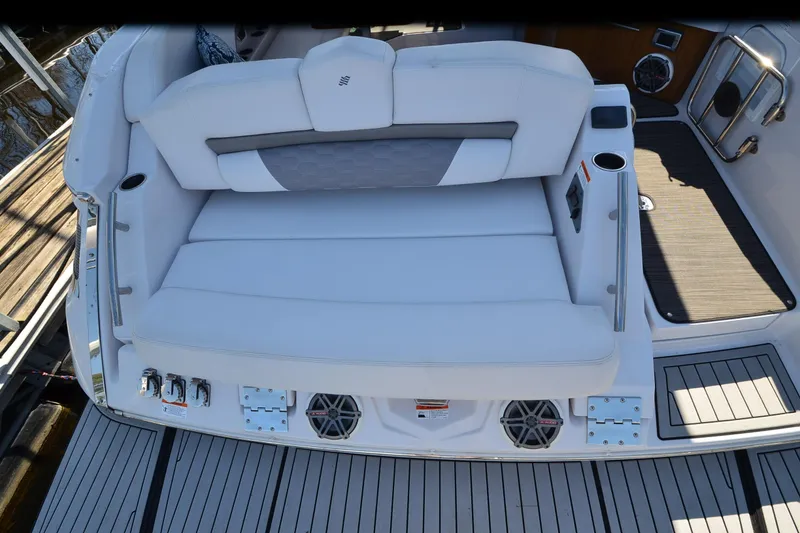 Slide: The Image of 2018 Four Winns H350 boat with white seating and deck, featuring cup holders and speakers. - 19