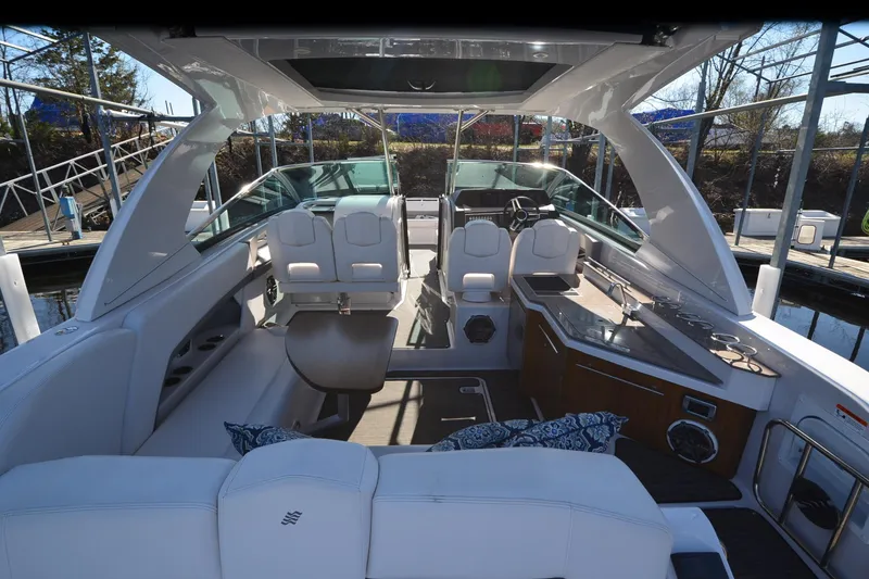 Slide: The Image of Luxurious interior of 2018 Four Winns H350 boat with seating and kitchenette. - 20