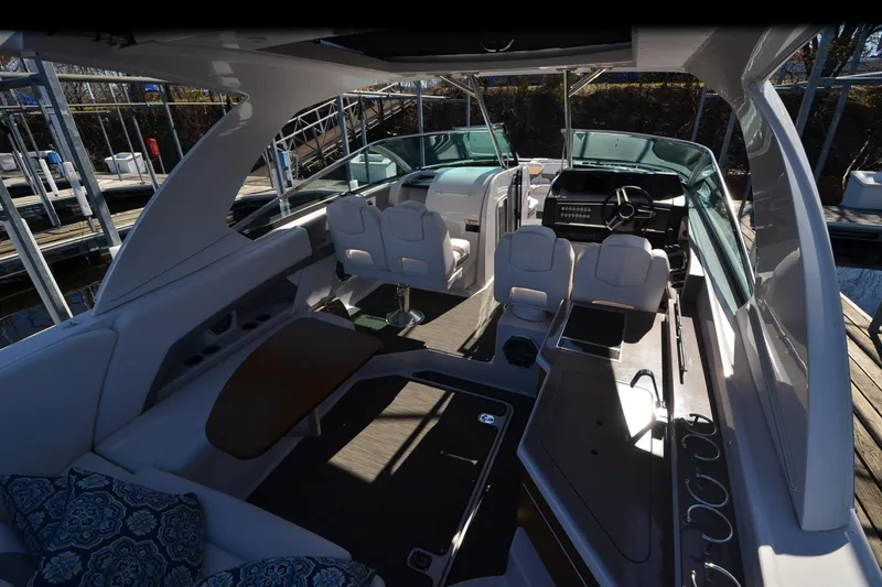 Slide: The Image of 2018 Four Winns H350 boat interior with seating, helm, and modern amenities. - 21