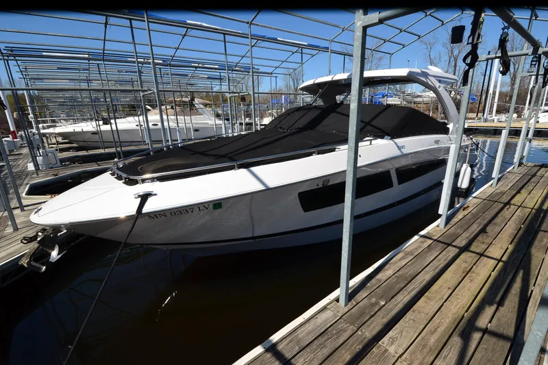 Slide: The Image of 2018 Four Winns H350 boat docked in marina, covered and ready for use. - 24