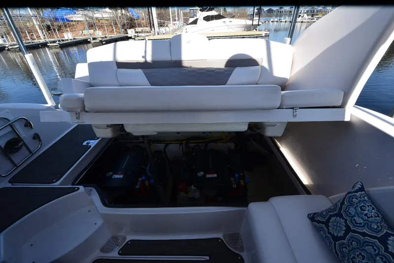 Slide: The Image of 2018 Four Winns H350 boat engine compartment with open seating, dockside view. - 27