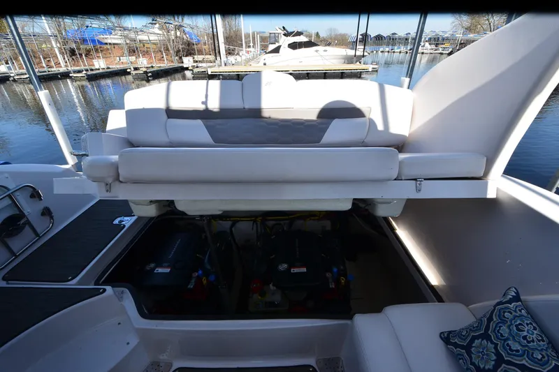 Slide: The Image of 2018 Four Winns H350 boat engine compartment with open seating, docked at marina. - 28