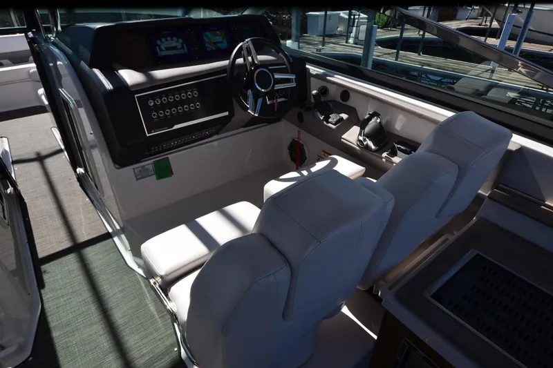 Slide: The Image of 2018 Four Winns H350 boat cockpit with dual seats and modern dashboard controls. - 31
