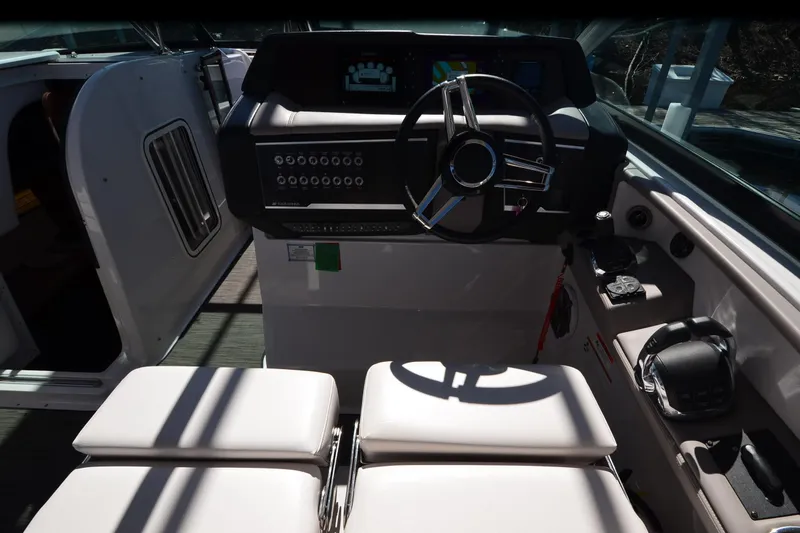 Slide: The Image of 2018 Four Winns H350 boat cockpit with steering wheel and control panel. - 32