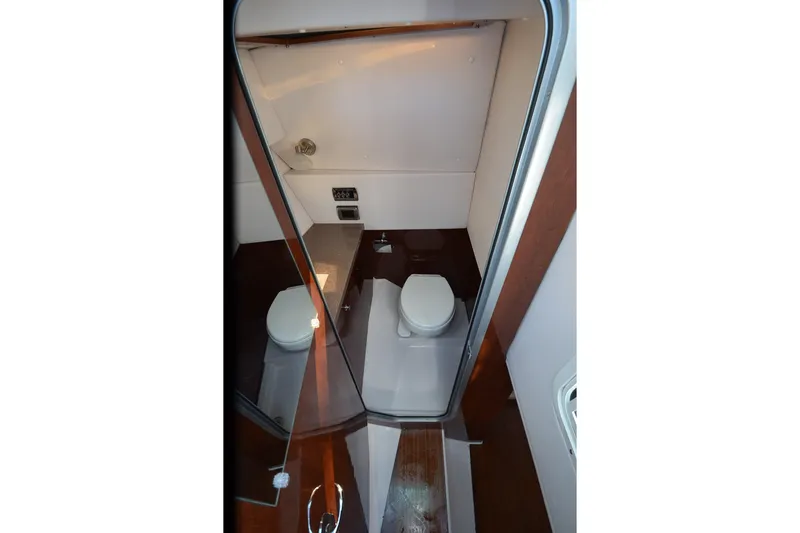 Slide: The Image of 2018 Four Winns H350 boat bathroom interior with modern fixtures and compact design. - 33