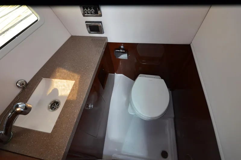 Slide: The Image of 2018 Four Winns H350 boat bathroom with sink, toilet, and countertop. - 34