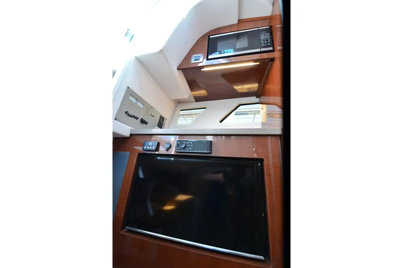 Slide: The Image of Interior of 2018 Four Winns H350 boat featuring modern appliances and sleek design. - 35