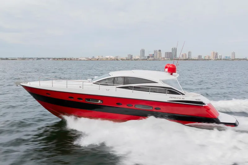 The Image of 2007 Pershing 56 yacht cruising on water with city skyline in background. - 1