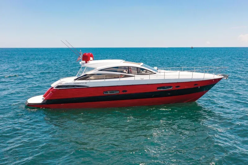 Slide: The Image of 2007 Pershing 56 yacht with red and white exterior on open sea. - 13