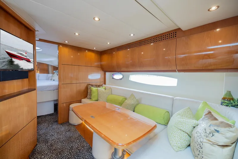 Slide: The Image of Luxurious interior of a 2007 Pershing 56 yacht with elegant wood finishes and plush seating. - 18