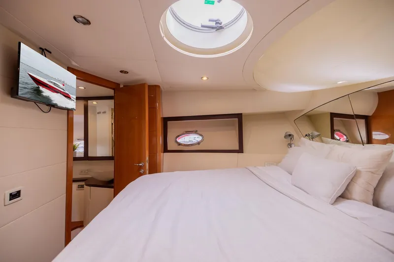 Slide: The Image of Luxurious 2007 Pershing 56 yacht bedroom with skylight, TV, and elegant decor. - 23