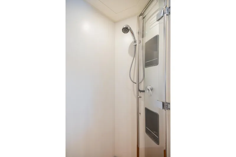 Slide: The Image of Shower area inside a 2007 Pershing 56 yacht, featuring modern fixtures and sleek design. - 25