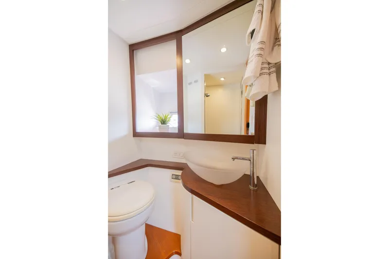 Slide: The Image of Luxurious bathroom interior of 2007 Pershing 56 yacht with modern fixtures and wooden accents. - 26