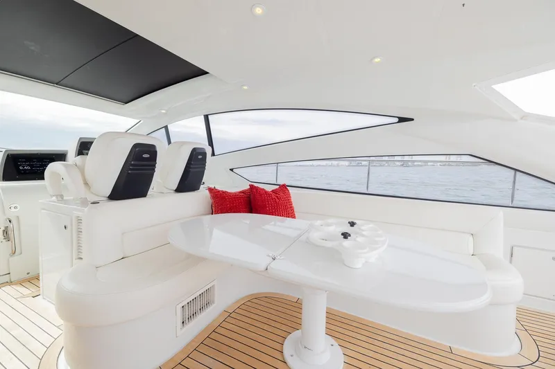 Slide: The Image of Luxurious interior of 2007 Pershing 56 yacht with white seating and red cushions. - 36