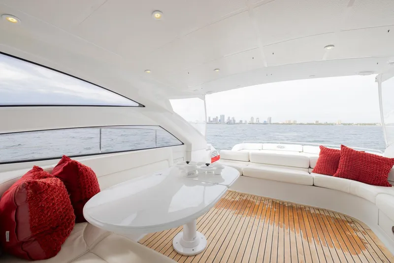 Slide: The Image of Luxurious 2007 Pershing 56 yacht interior with red cushions and ocean view. - 38