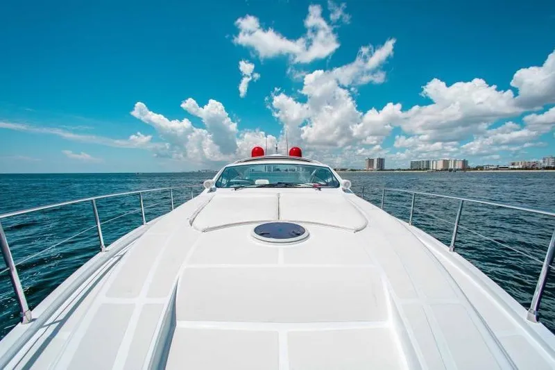 Slide: The Image of 2007 Pershing 56 yacht cruising on open water under a clear blue sky. - 4